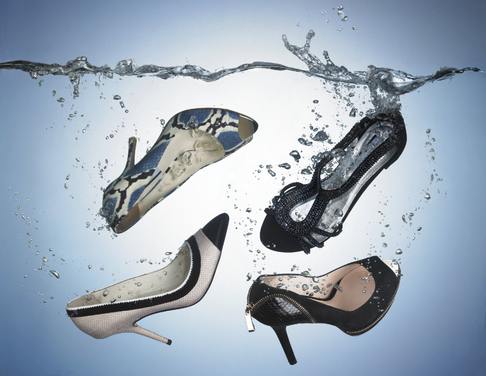 Four women's shoes in water – Photograph by George Ong