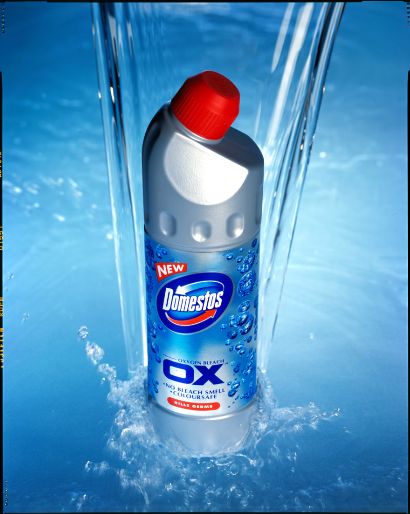 Water pouring over Domestos bottle – Photograph by George Ong