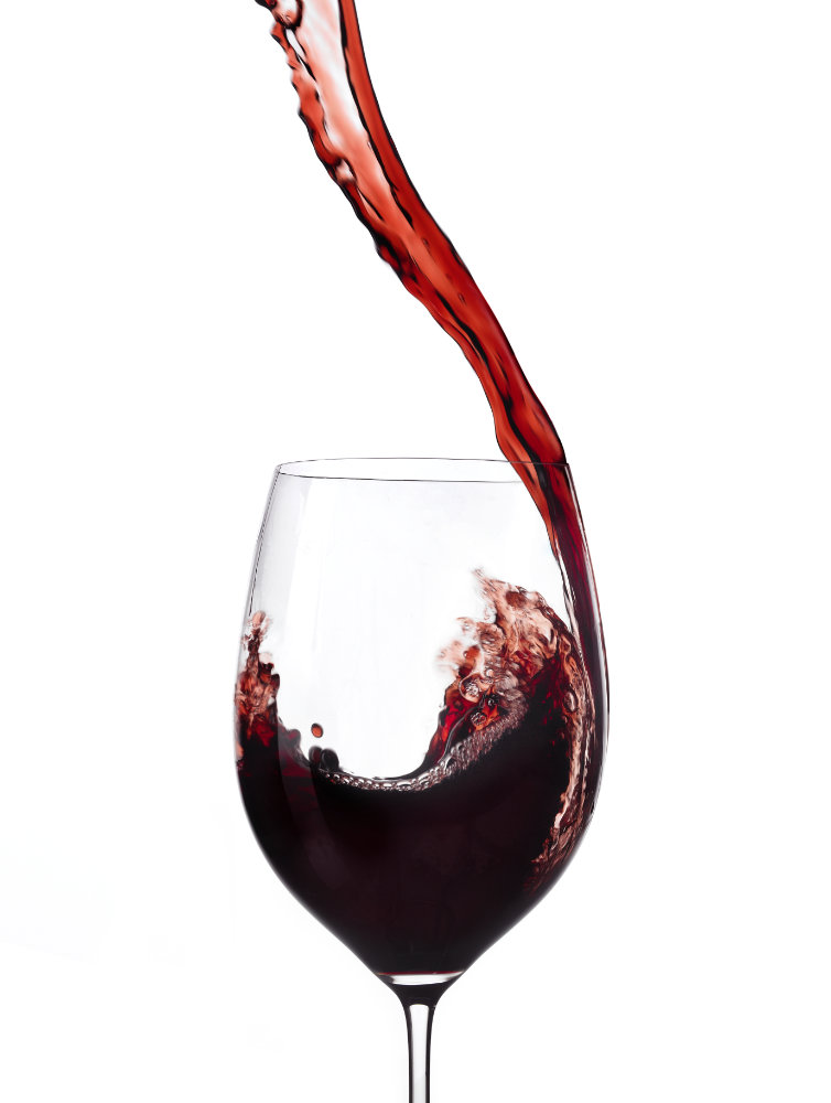 Action shot of wine poured into wine glass – Photograph by George Ong