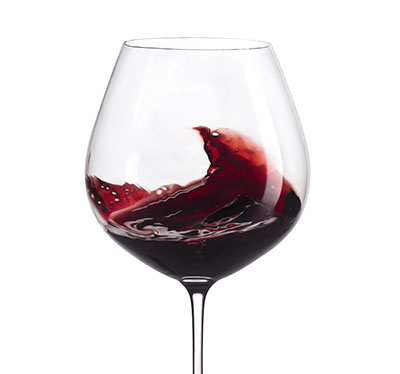 Action shot of wine swirled in wine glass – Photograph by George Ong