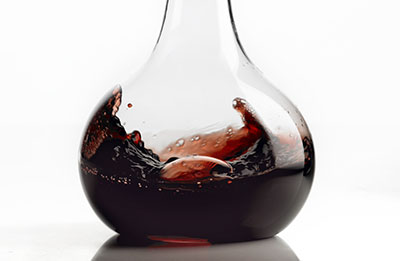 Tighter crop of red wine swirled in carafe – Photograph by George Ong