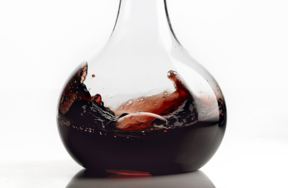 Tighter crop of red wine swirled in carafe – Photograph by George Ong